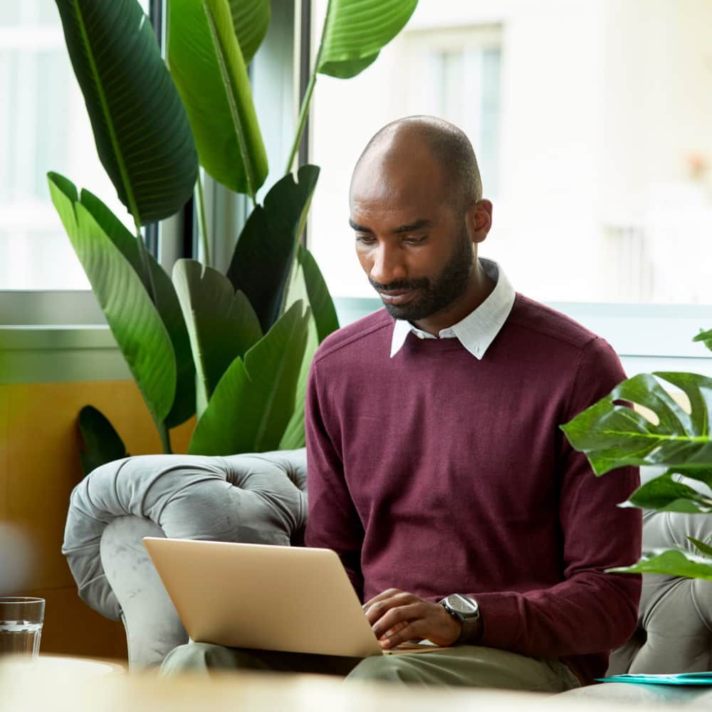 Person sitting at a desk looking at their computer